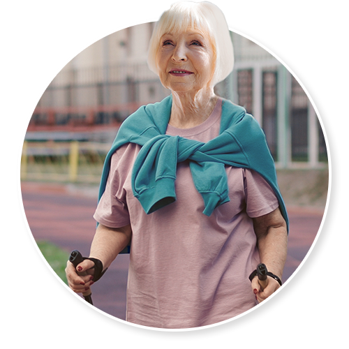 An older woman standing alone outdoors, a thoughtful expression